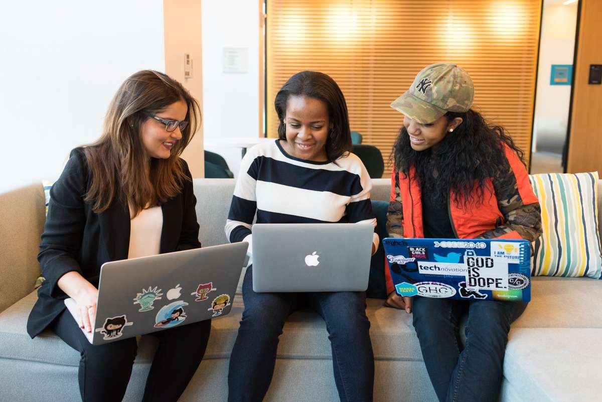 women in front of laptop learning online course